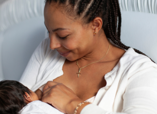 Nip Tips: Breastfeeding Hacks for Tired Mamas A woman breastfeeding her baby.