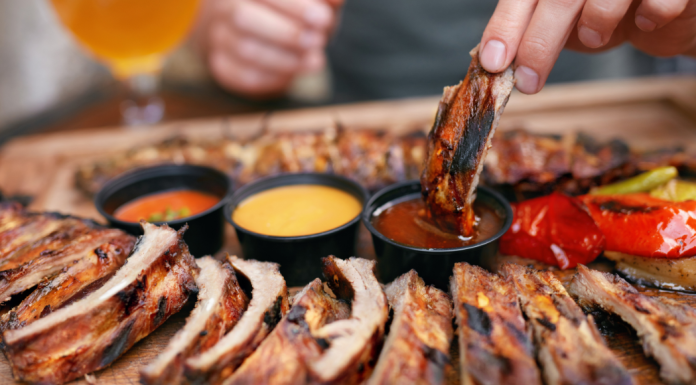 BBQ ribs dipped in sauce.