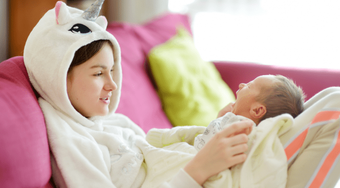 Older sister holding a newborn baby.