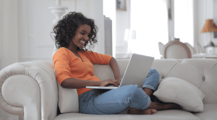 A woman looking something up on a computer.