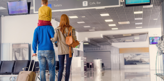 A family walking through an airport.