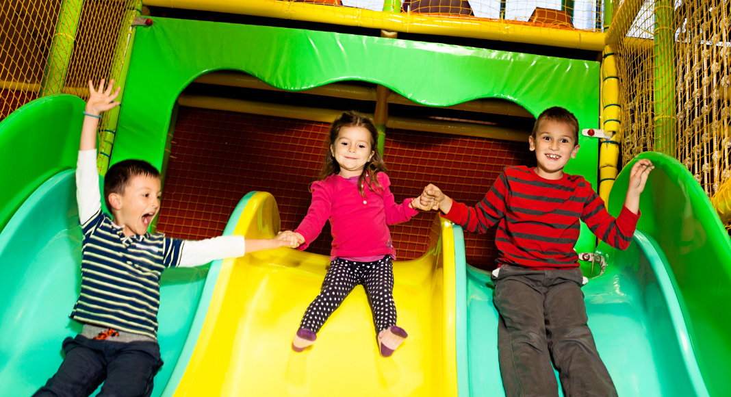 Kids on an indoor slide.