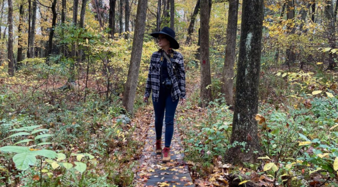 Janice walking along a path in the fall.