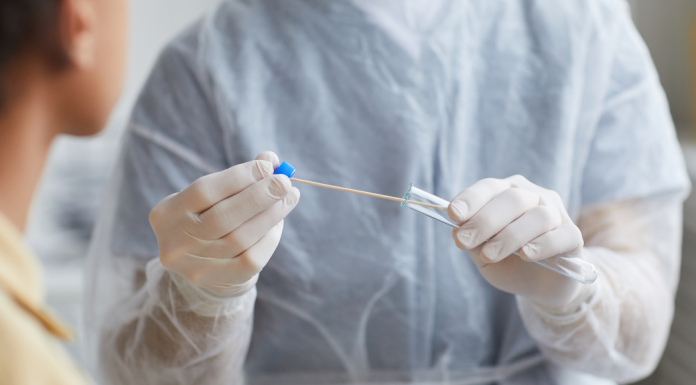 A doctor holding a COVID test.