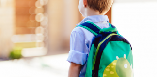A kindergarten boy wearing a backpack.