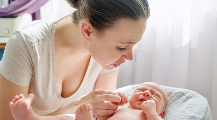 A mother looking at her newborn.