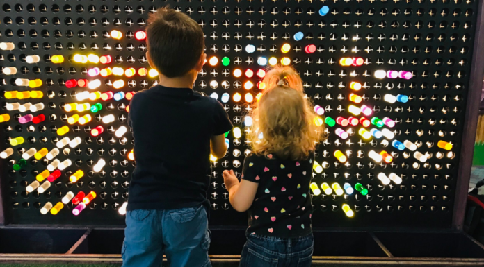 Kids playing with colored pegs at a local children's museum.