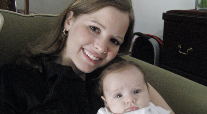 A mom holding her baby.