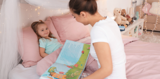 A mom reading a bedtime story to her daughter.