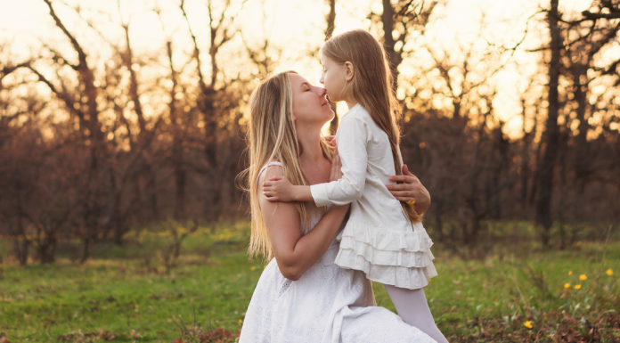 A mother embracing her daughter.
