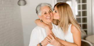 A woman kissing her grandmother.