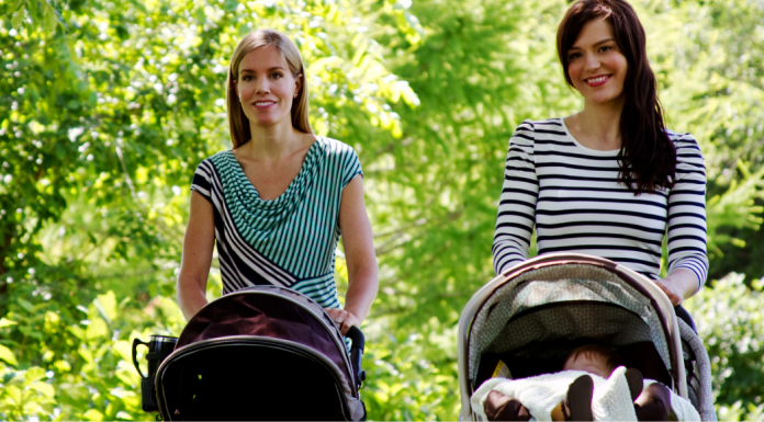 Two moms pushing strollers.