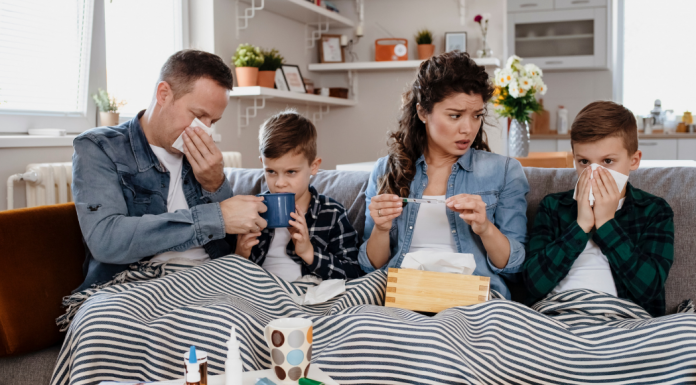A sick family sitting on the couch.