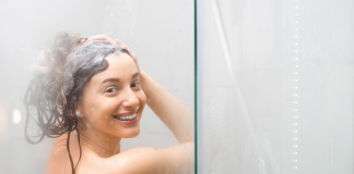 A woman washing her hair in the shower.