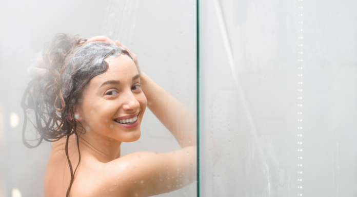 A woman washing her hair in the shower.