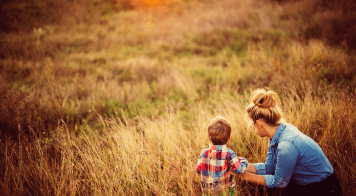 A mother in a field with her son.