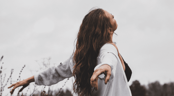 A woman feeling her freedom in an open field.