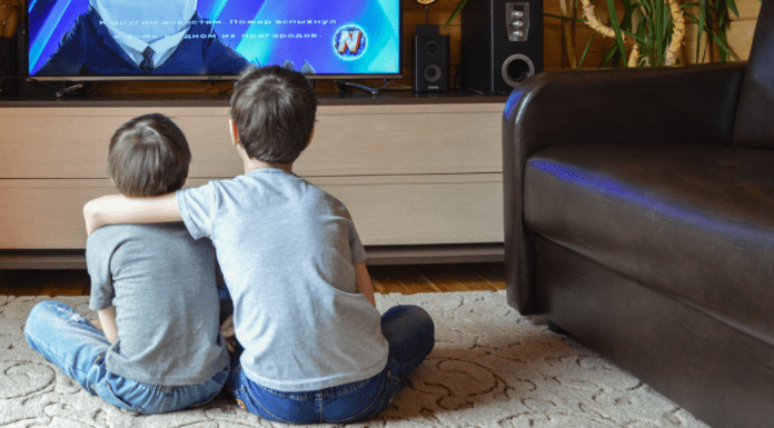 Two brothers watching TV.