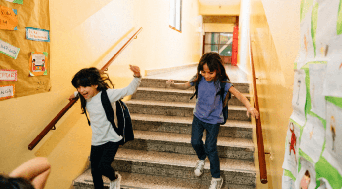 Two students racing down the school stairs.