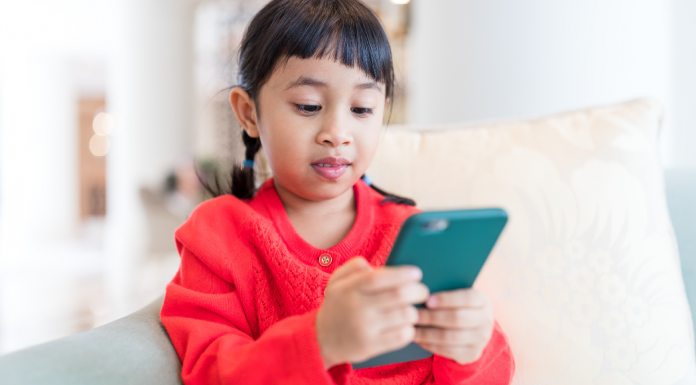 A young girl on an iPhone.