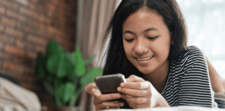 A teen on a cell phone.