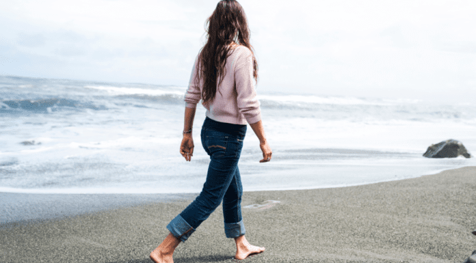 A woman walking on a beach.
