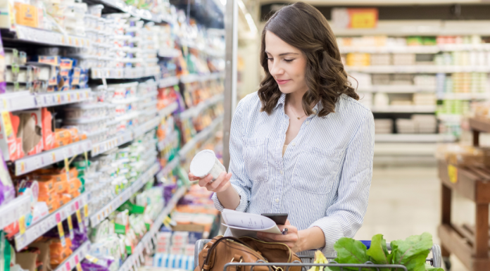A woman grocery shopping alone.