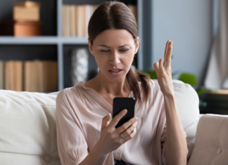 When You’re in a Negative Place A frustrated woman looking at her phone.