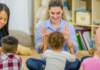 Moms clapping hands with their toddlers at a Mommy and Me class.