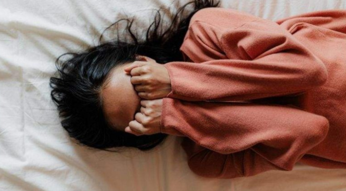 A woman covering her face in frustration.