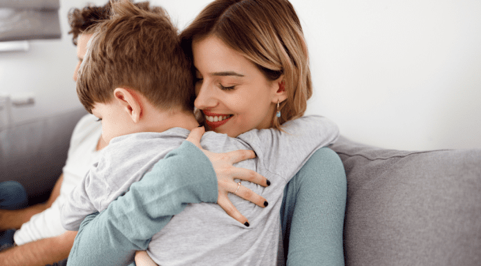 A mother hugging her son.