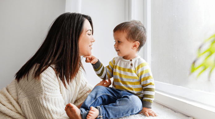 A mom looking in her toddlers eyes.