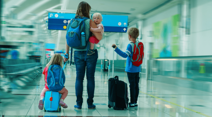A mom in an airport with kids.