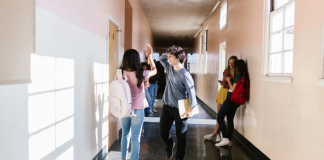 Kids walking in a school hallway.