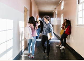Kids walking in a school hallway.