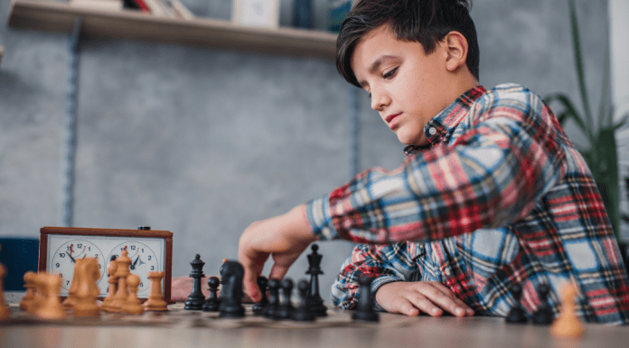 A boy playing chess.