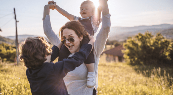 A woman celebrating life with her children.