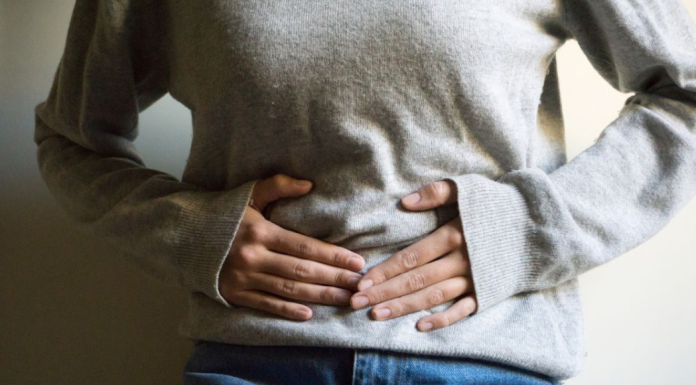 A woman holding her stomach.