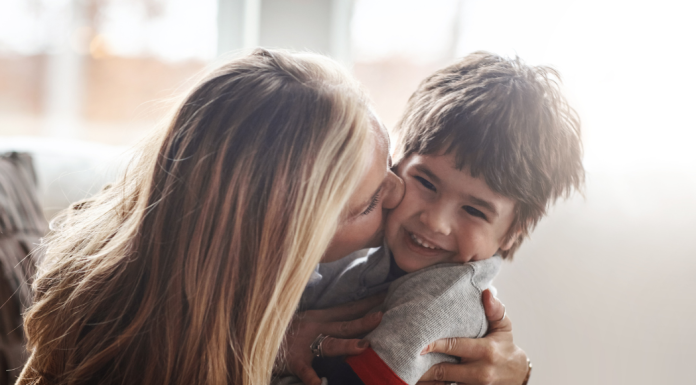 A mom kissing her son
