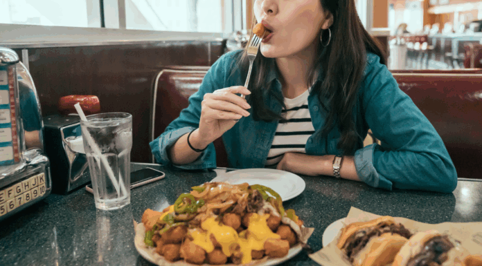 A woman enjoying food at a local diner.