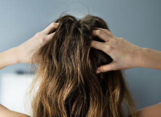A woman massaging her scalp.