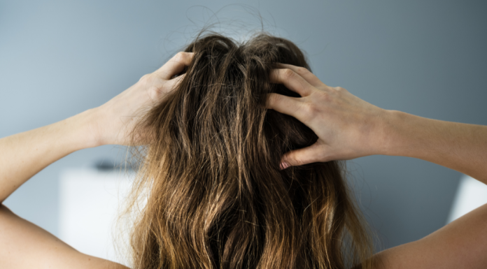 A woman massaging her scalp.