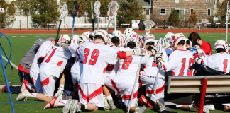 A team huddle for lacrosse players.