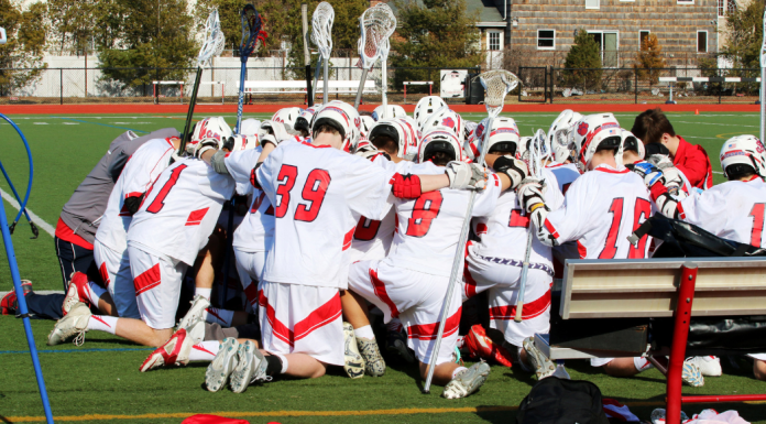 A team huddle for lacrosse players.