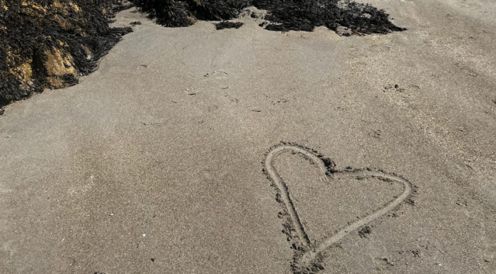 A heart drawn in the sand.