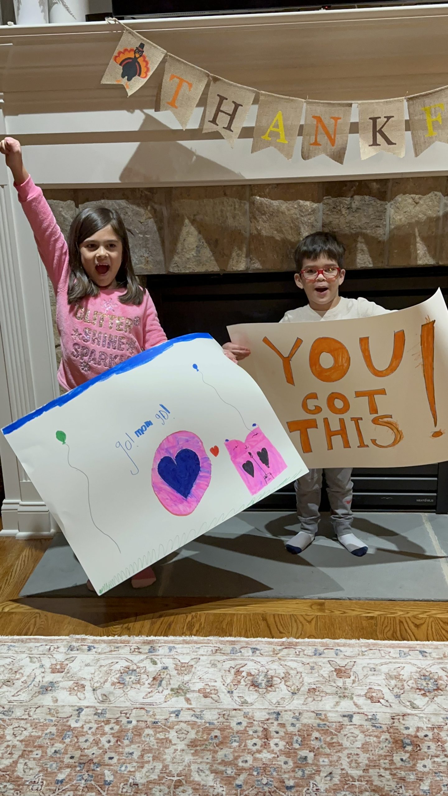 Kids making signs to support their mom.
