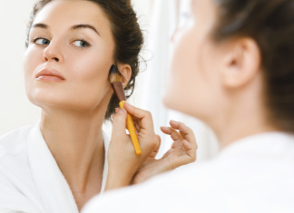 A woman applying makeup.