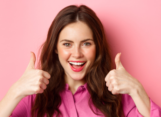 A woman giving a double thumbs up.