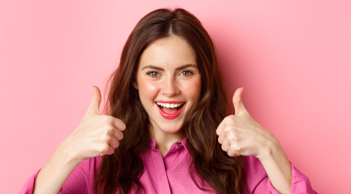 A woman giving a double thumbs up.