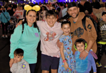 A family posing for a photo at Disney World.